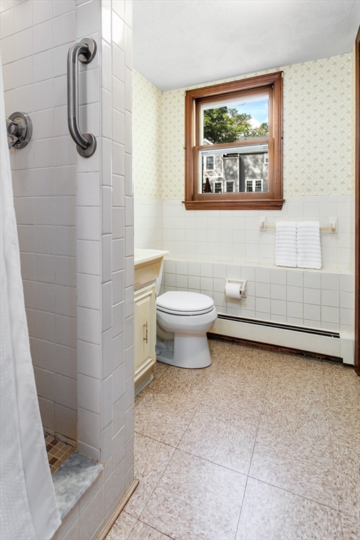 9 Hemlock Road Reading, MA 01867 - Photo 29 of 42 a bathroom with a toilet a sink and shower