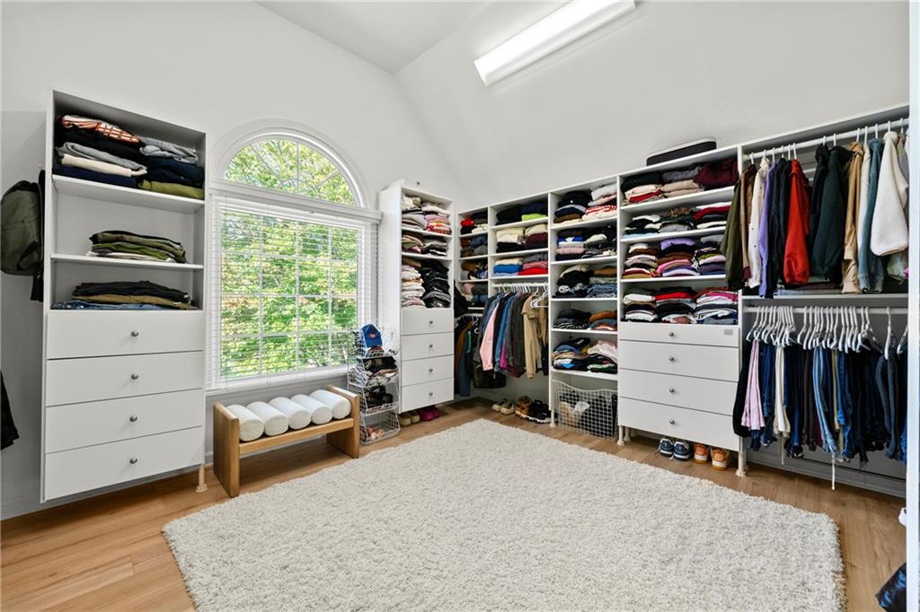 12579 Huntington Trace Alpharetta, GA 30005 - Photo 14 of 64 a view of walk in closet with clothes and shoes