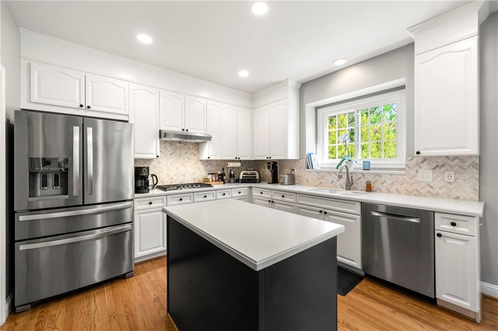 12579 Huntington Trace Alpharetta, GA 30005 - Photo 24 of 64 a kitchen with a sink stove and refrigerator