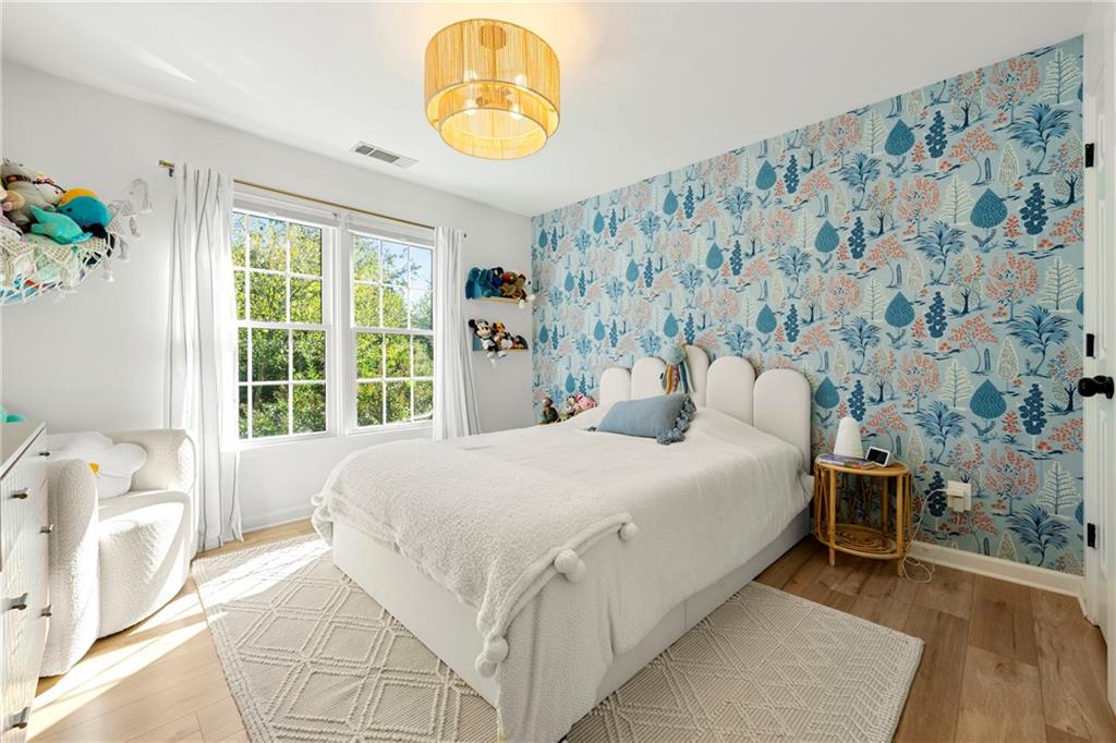 12579 Huntington Trace Alpharetta, GA 30005 - Photo 31 of 64 a bedroom with a bed and a large window