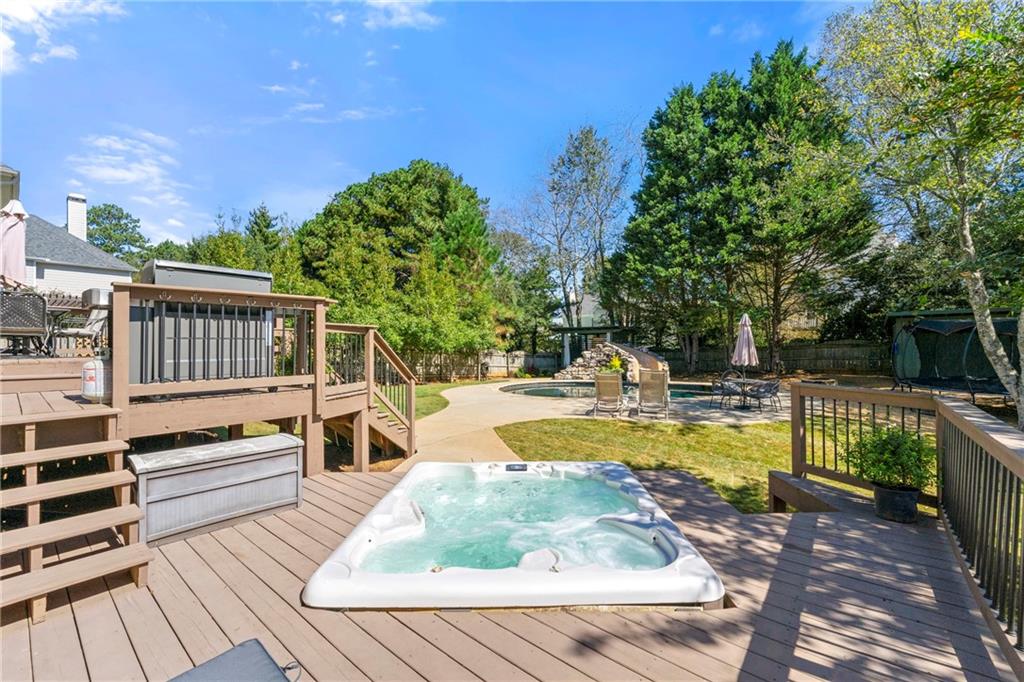 12579 Huntington Trace Alpharetta, GA 30005 - Photo 52 of 64 a view of a swimming pool with a patio
