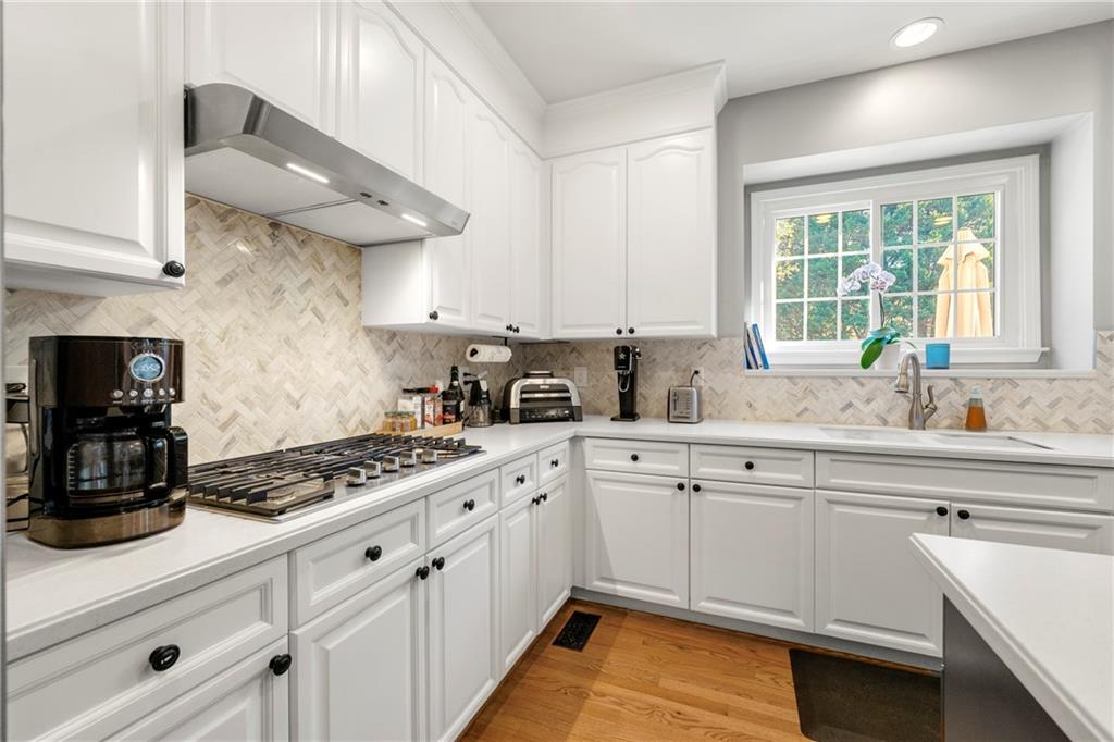 12579 Huntington Trace Alpharetta, GA 30005 - Photo 6 of 64 a kitchen with stainless steel appliances a sink stove and cabinets