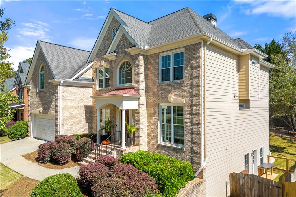 12579 Huntington Trace Alpharetta, GA 30005 - Photo 62 of 64 a view of a white house next to a yard