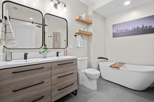 841 West Monroe Street, Unit 4A Chicago, IL 60607 - Photo 17 of 30 a bathroom with a granite countertop toilet a sink and a mirror