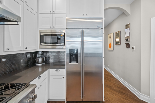 841 West Monroe Street, Unit 4A Chicago, IL 60607 - Photo 4 of 30 a kitchen with stainless steel appliances a refrigerator a stove and cabinets
