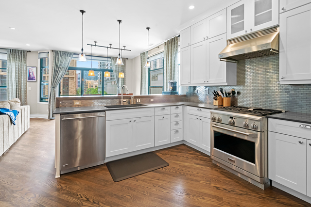 841 West Monroe Street, Unit 4A Chicago, IL 60607 - Photo 5 of 30 a kitchen with stainless steel appliances granite countertop a sink a stove and a refrigerator