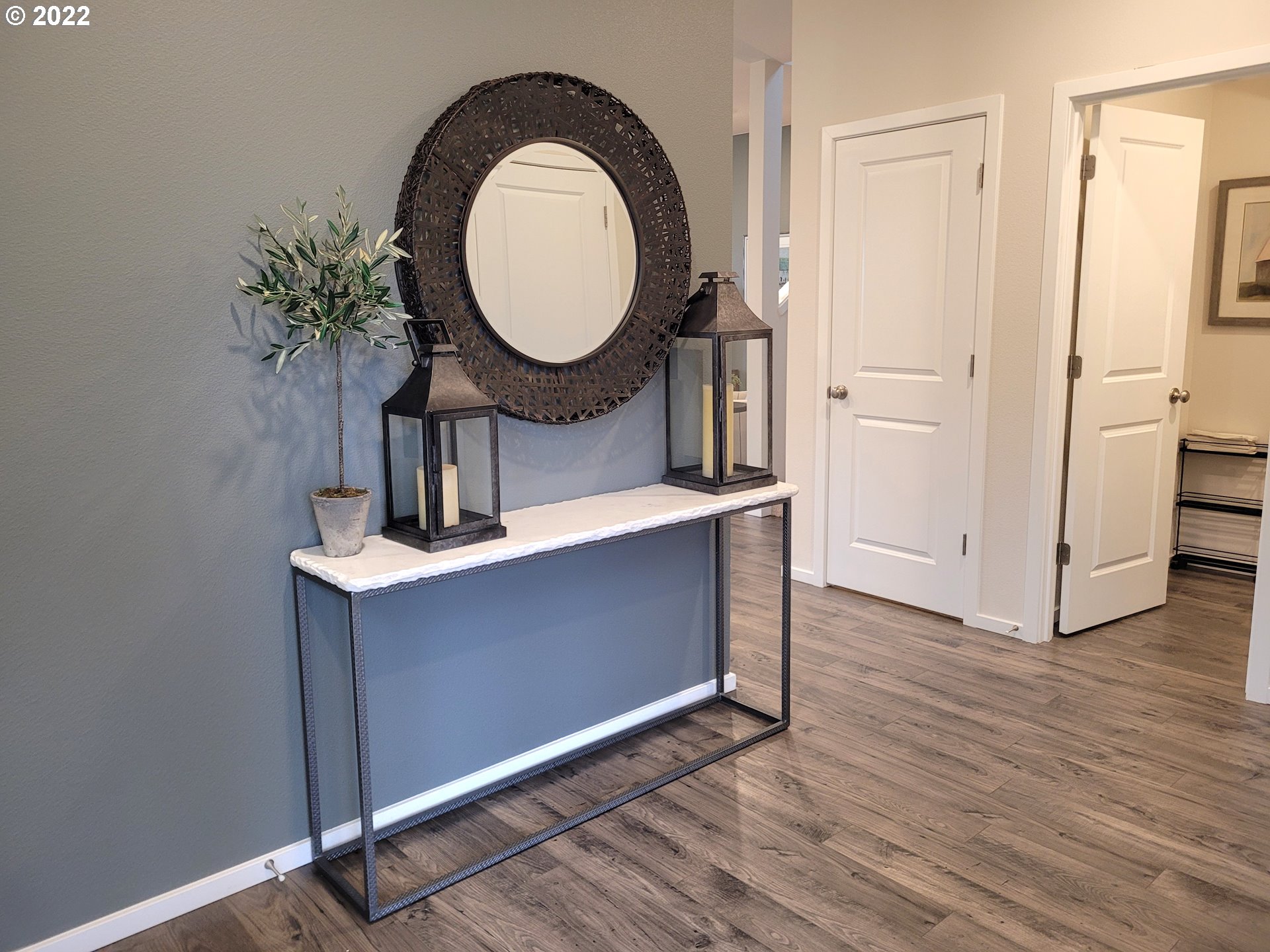 2694 Fenya Street Springfield, OR 97477 - Photo 3 of 17 a room with wooden floor a mirror and a potted plant