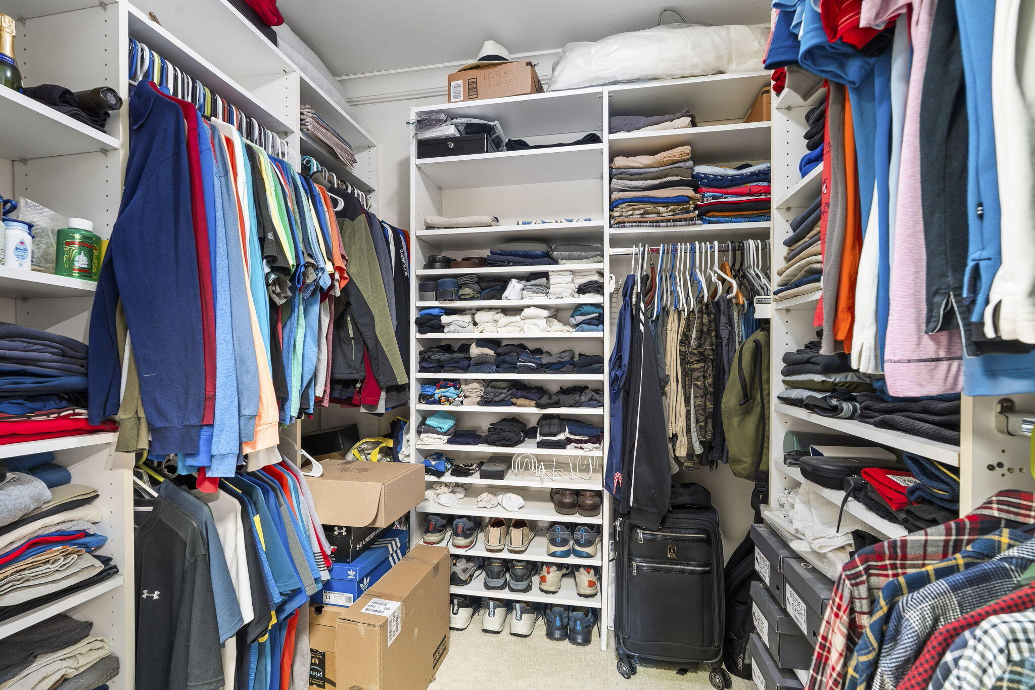 3374 Southeast Fairway East Stuart, FL 34997 - Photo 22 of 65 a view of walk in closet with clothes and shoes