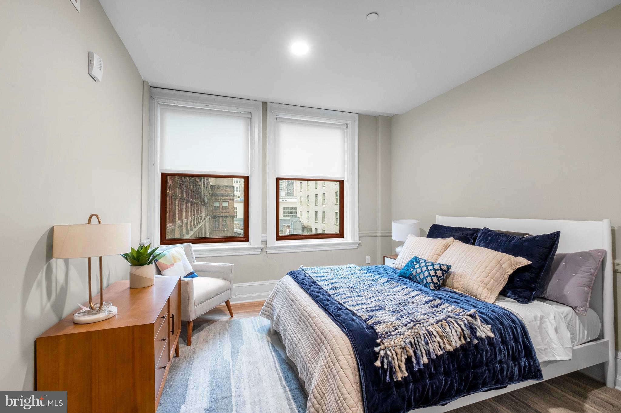 1420-22 Chestnut Street, Unit 301 Philadelphia, PA 19102 - Photo 11 of 29 a bedroom with a bed and wooden floor