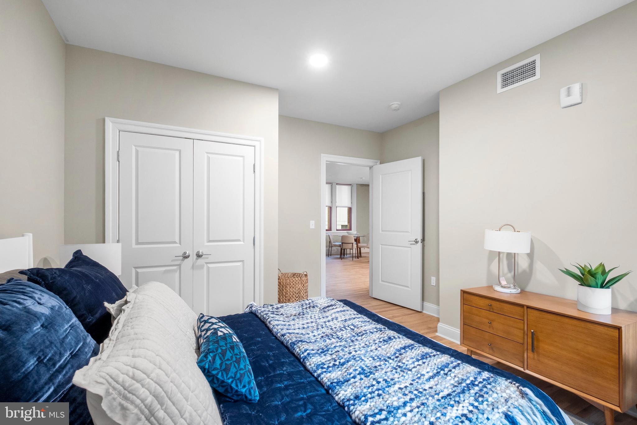 1420-22 Chestnut Street, Unit 301 Philadelphia, PA 19102 - Photo 13 of 29 a spacious bedroom with a bed and wooden floor
