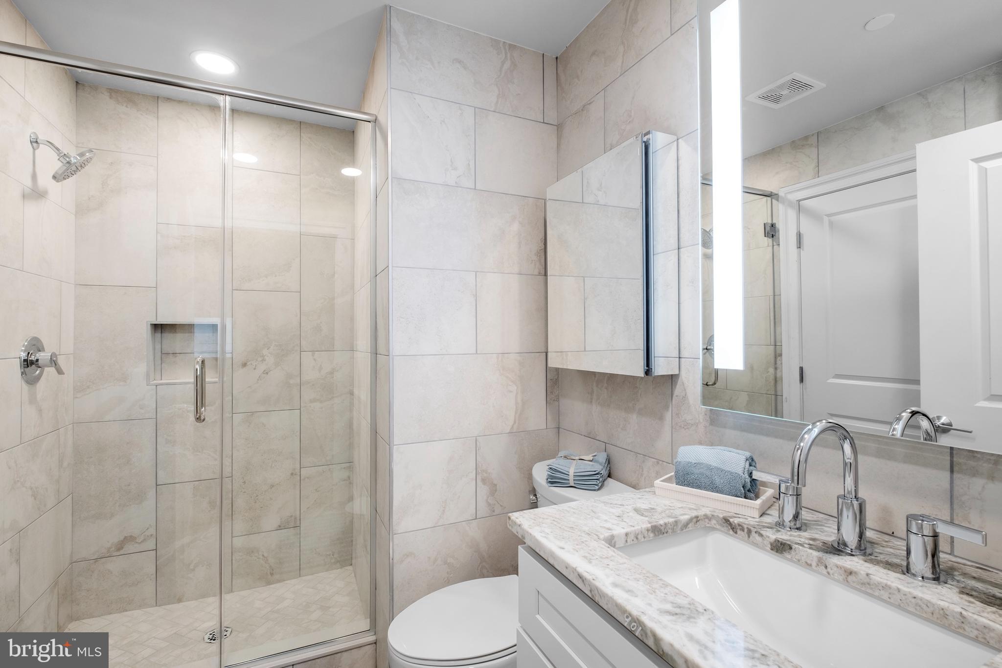 1420-22 Chestnut Street, Unit 301 Philadelphia, PA 19102 - Photo 14 of 29 a bathroom with a granite countertop sink toilet and shower