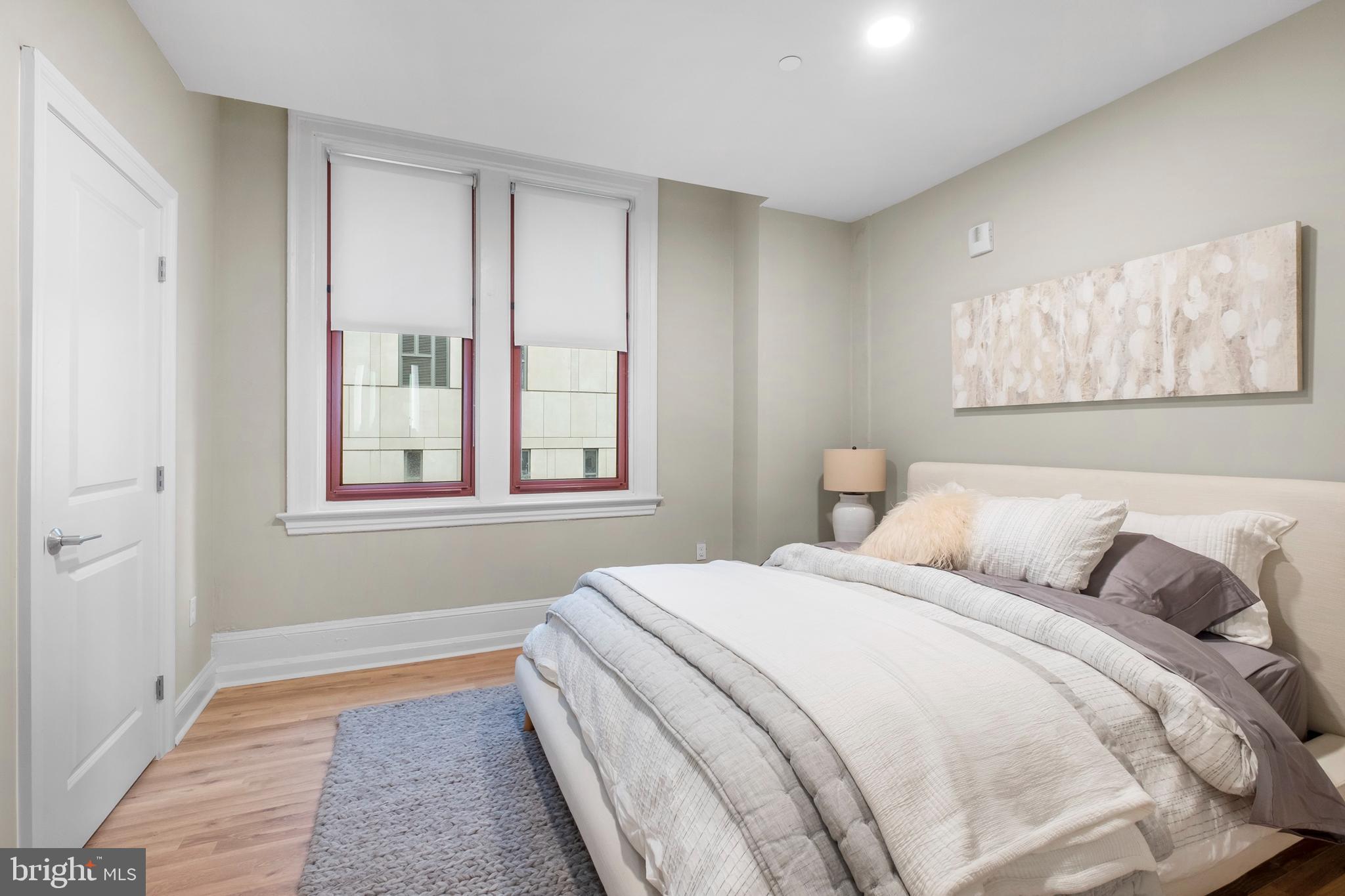 1420-22 Chestnut Street, Unit 301 Philadelphia, PA 19102 - Photo 16 of 29 a bedroom with a bed and a window