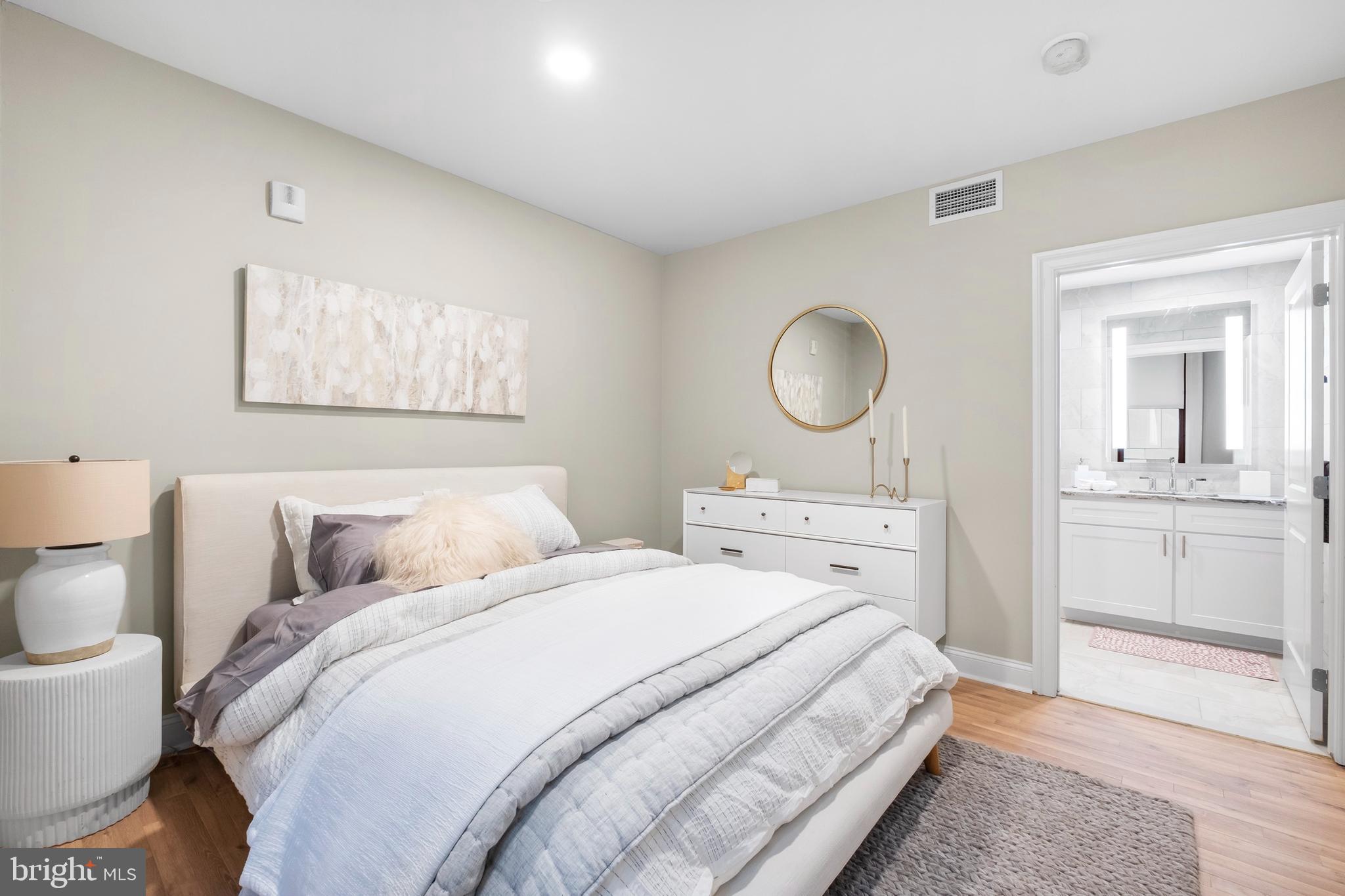 1420-22 Chestnut Street, Unit 301 Philadelphia, PA 19102 - Photo 18 of 29 a bedroom with a bed and a chandelier