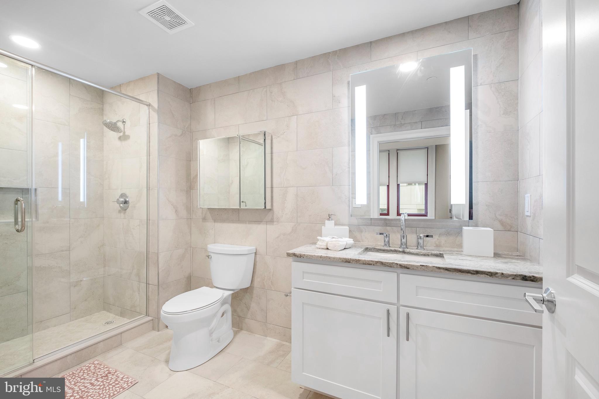1420-22 Chestnut Street, Unit 301 Philadelphia, PA 19102 - Photo 19 of 29 a bathroom with a sink a toilet and shower