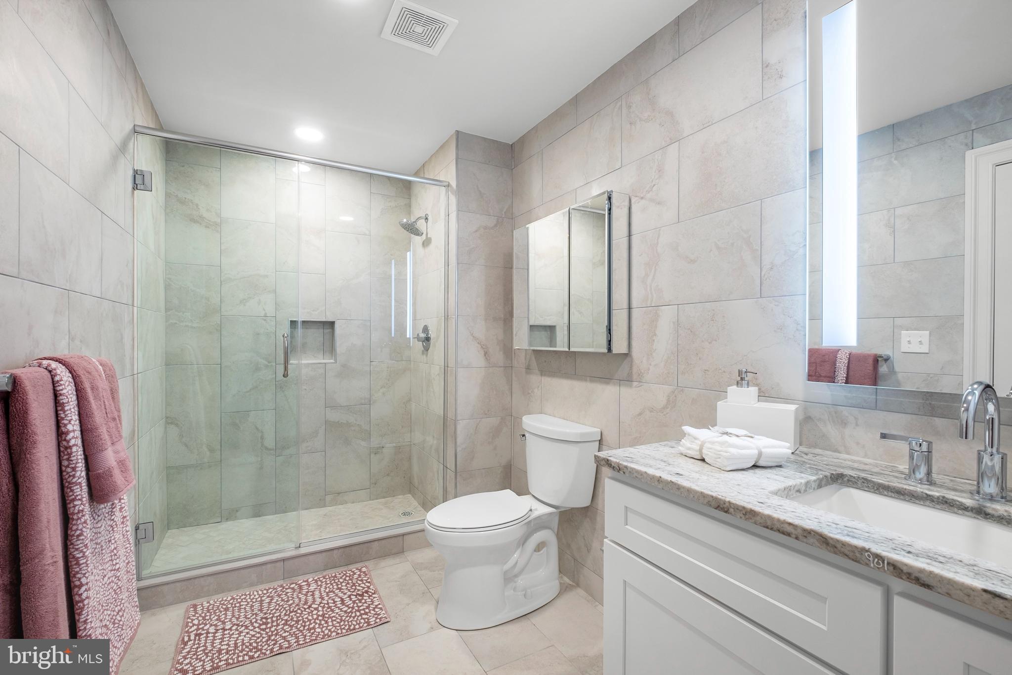 1420-22 Chestnut Street, Unit 301 Philadelphia, PA 19102 - Photo 20 of 29 a bathroom with a granite countertop sink a toilet and shower