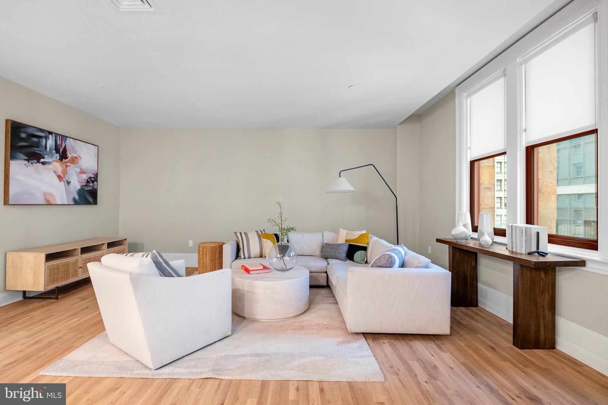 1420-22 Chestnut Street, Unit 301 Philadelphia, PA 19102 - Photo 2 of 29 a living room with furniture and a table