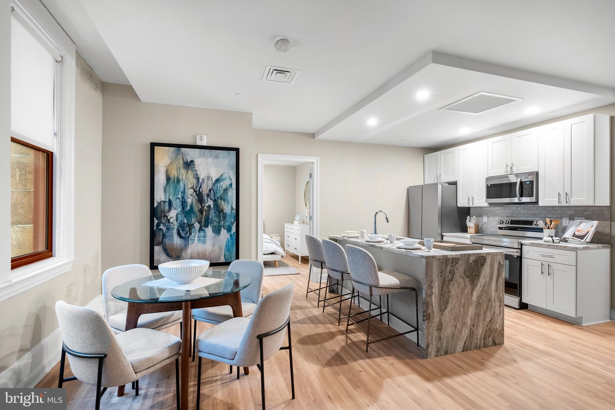 1420-22 Chestnut Street, Unit 301 Philadelphia, PA 19102 - Photo 5 of 29 a view of a dining room with furniture and wooden floor