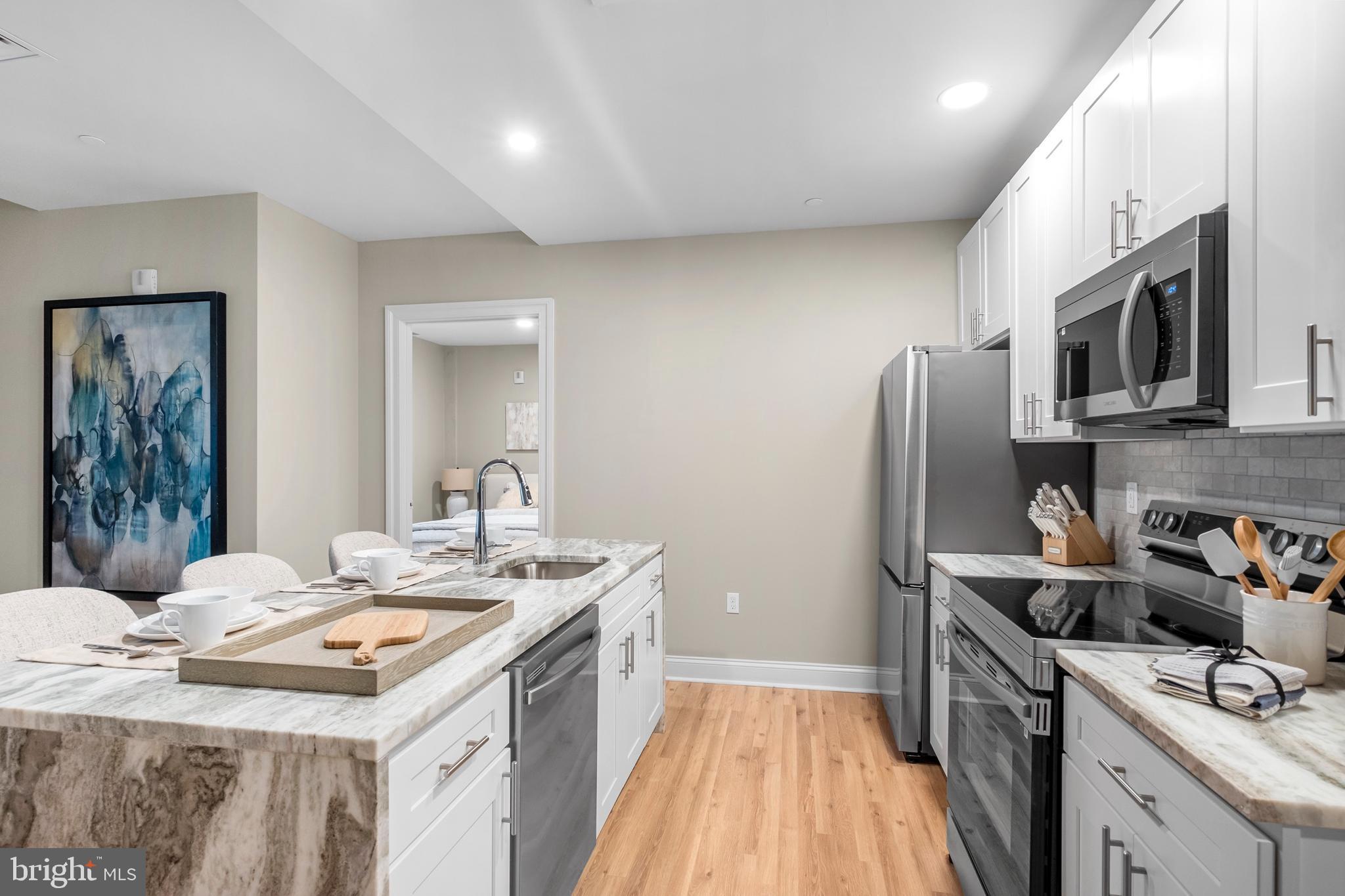 1420-22 Chestnut Street, Unit 301 Philadelphia, PA 19102 - Photo 7 of 29 a kitchen that has a sink a stove and refrigerator