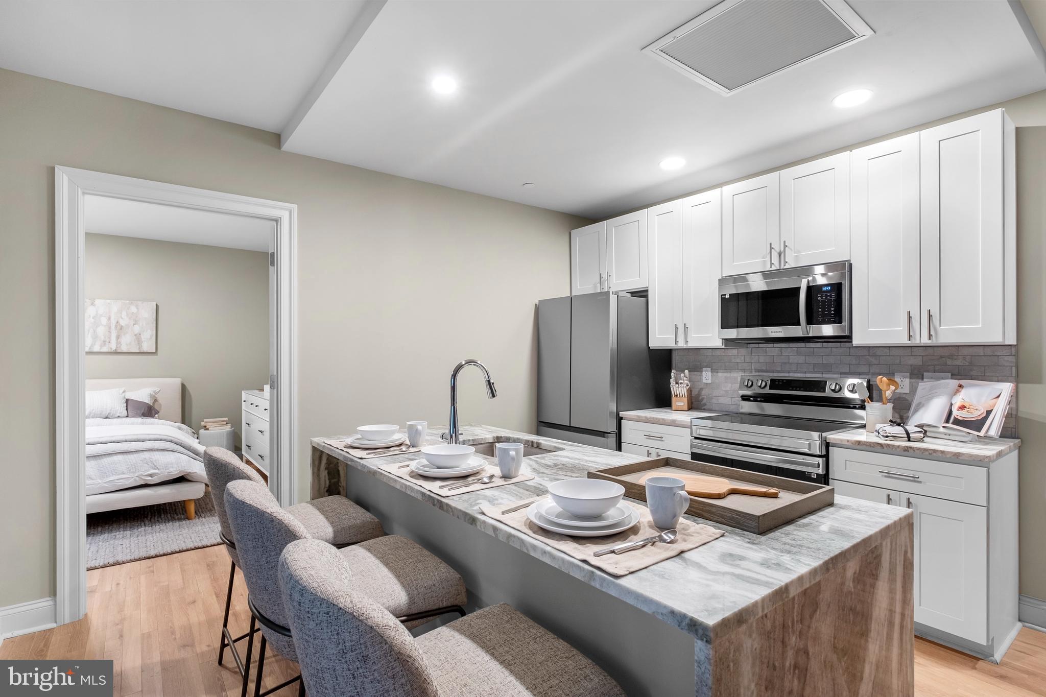 1420-22 Chestnut Street, Unit 301 Philadelphia, PA 19102 - Photo 9 of 29 a kitchen with a sink stove and refrigerator