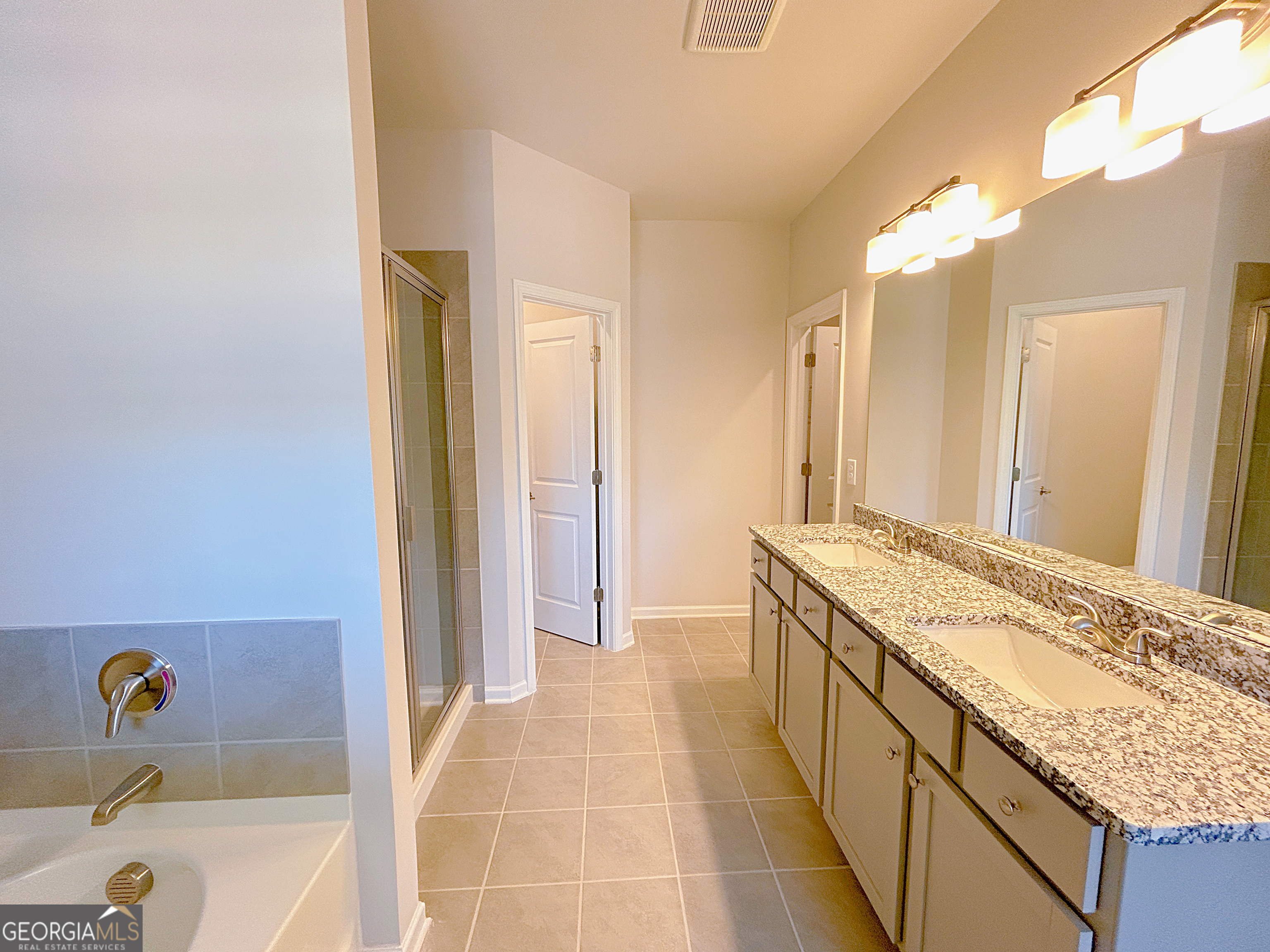 2594 Mills Commons Drive Decatur, GA 30034 - Photo 4 of 10 a spacious bathroom with a granite countertop tub sink and mirror