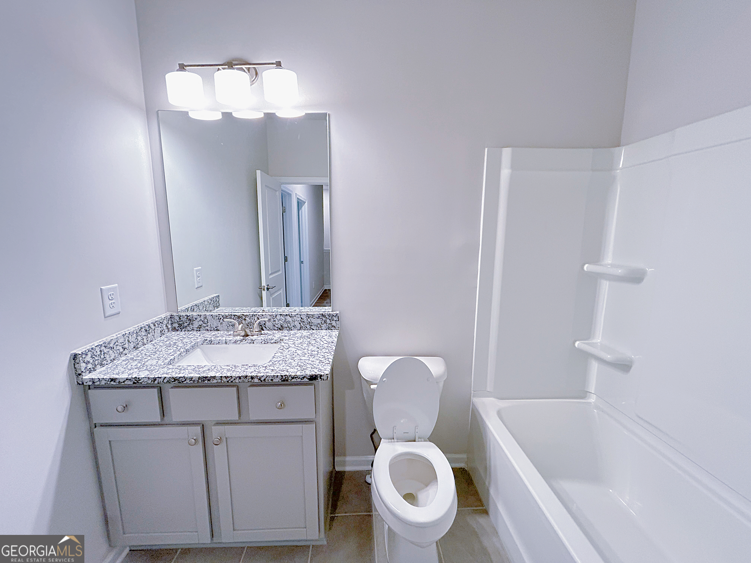 2594 Mills Commons Drive Decatur, GA 30034 - Photo 5 of 10 a bathroom with a granite countertop sink toilet mirror and bathtub