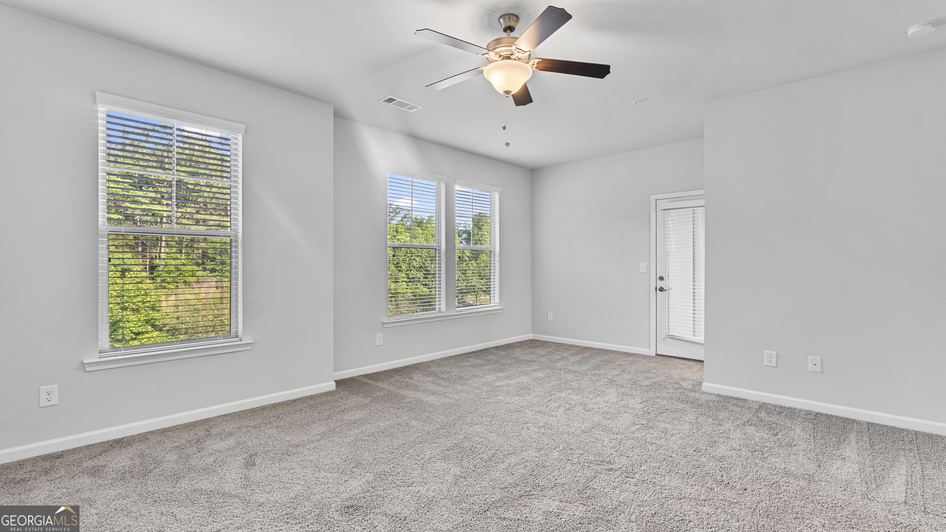 2594 Mills Commons Drive Decatur, GA 30034 - Photo 8 of 10 an empty room with windows and fan