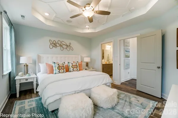 a bedroom with a large bed and a chandelier