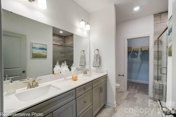a bathroom with a double vanity sink mirror and double