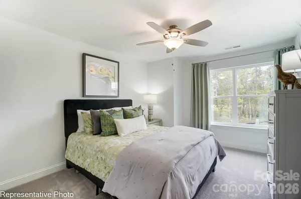 a bedroom with a large bed and a window