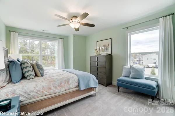 a bedroom with bed and glass window