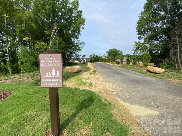 a sign board with yard in the back