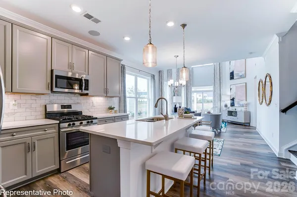 a large kitchen with granite countertop lots of counter space a sink and appliances