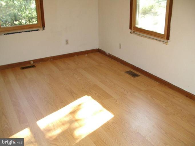 157 Remount View Road Front Royal, VA 22630 - Photo 4 of 13 a view of a big room with wooden floor and a window