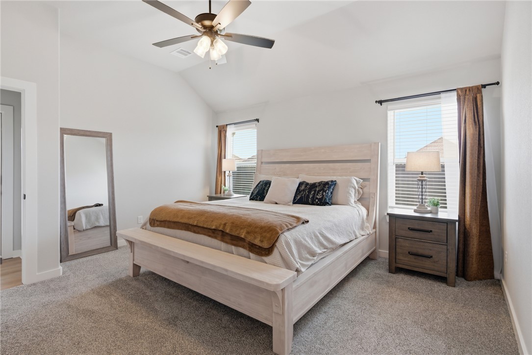 3112 Margaret Rudder Parkway Bryan, TX 77808 - Photo 12 of 24 a bedroom with a bed and a chandelier