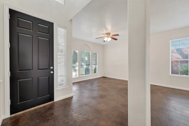 an empty room with windows and closet