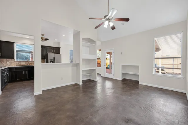 a view of a kitchen with a sink dishwasher oven window and wooden floor