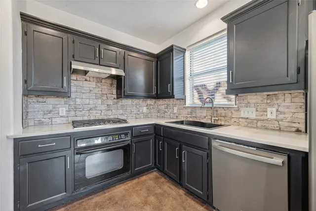 a kitchen with stainless steel appliances granite countertop a sink stove and microwave