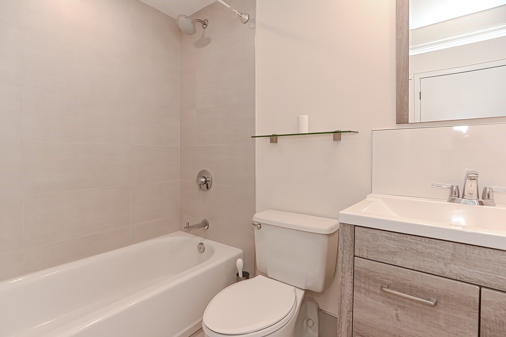 59 Brainerd Road, Unit 406 Boston, MA 02134 - Photo 12 of 19 a bathroom with a sink toilet vanity and bathtub