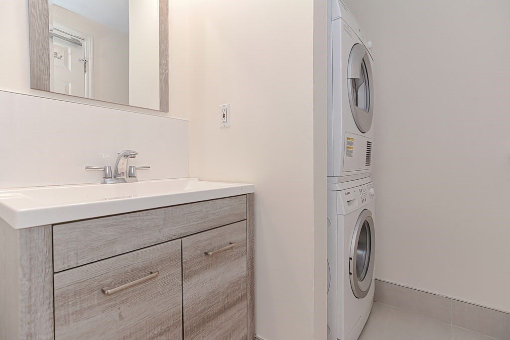 59 Brainerd Road, Unit 406 Boston, MA 02134 - Photo 14 of 19 a bathroom with a sink and a washer dryer