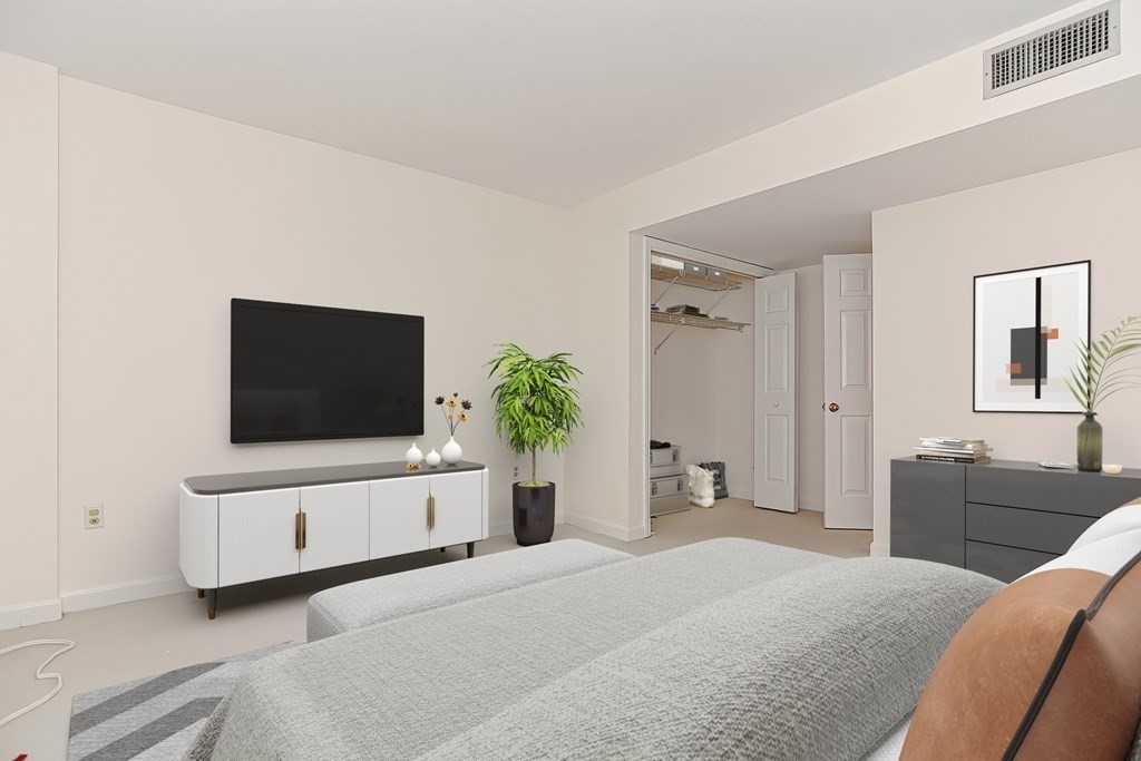 59 Brainerd Road, Unit 406 Boston, MA 02134 - Photo 4 of 19 a bedroom with a bed and a flat screen tv