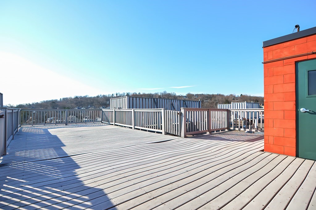 59 Brainerd Road, Unit 406 Boston, MA 02134 - Photo 5 of 19 a view of a balcony with wooden floor and city view