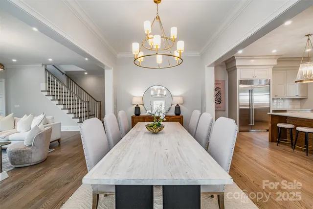 a view of a dining room with furniture wooden floor and chandelier