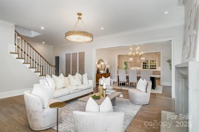 a living room with furniture and a chandelier