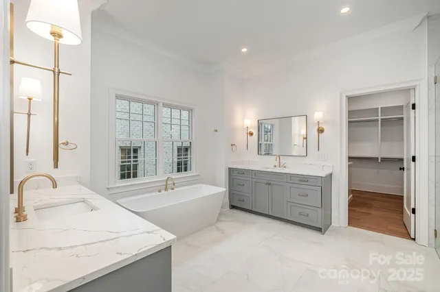 a bathroom with a granite countertop sink mirror and bathtub