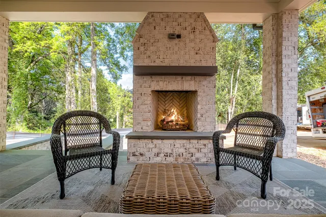 a view of a chair and fire pit in the backyard