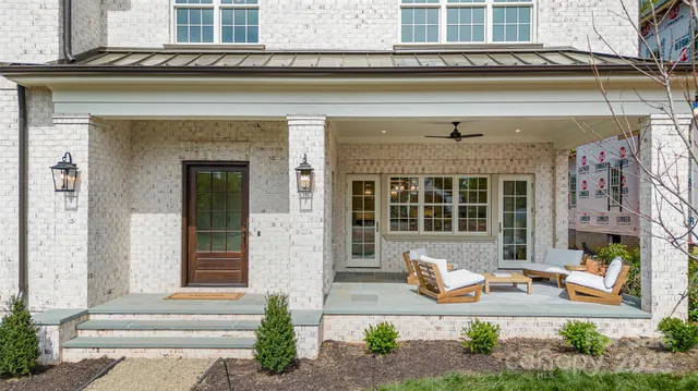 a front view of a house with outdoor seating