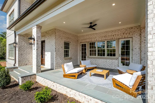 a view of a hall way with furniture and floor to ceiling window