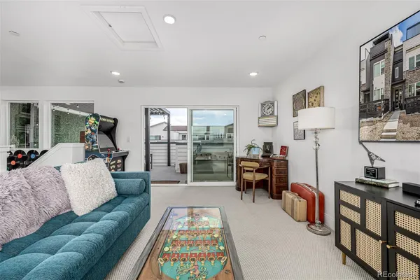 a bedroom with a bed couch and window