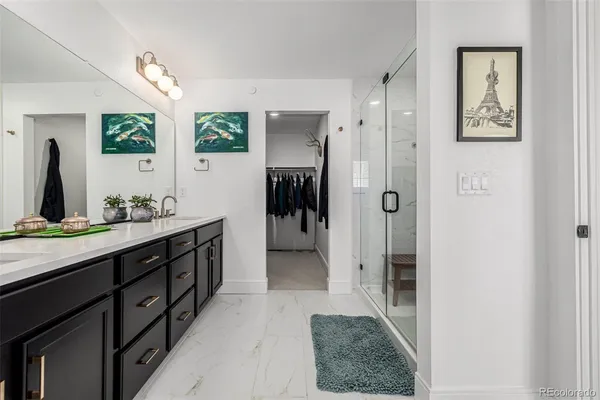 a view of walk in closet with clothes and shoes