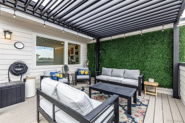 a view of a terrace with lawn chairs